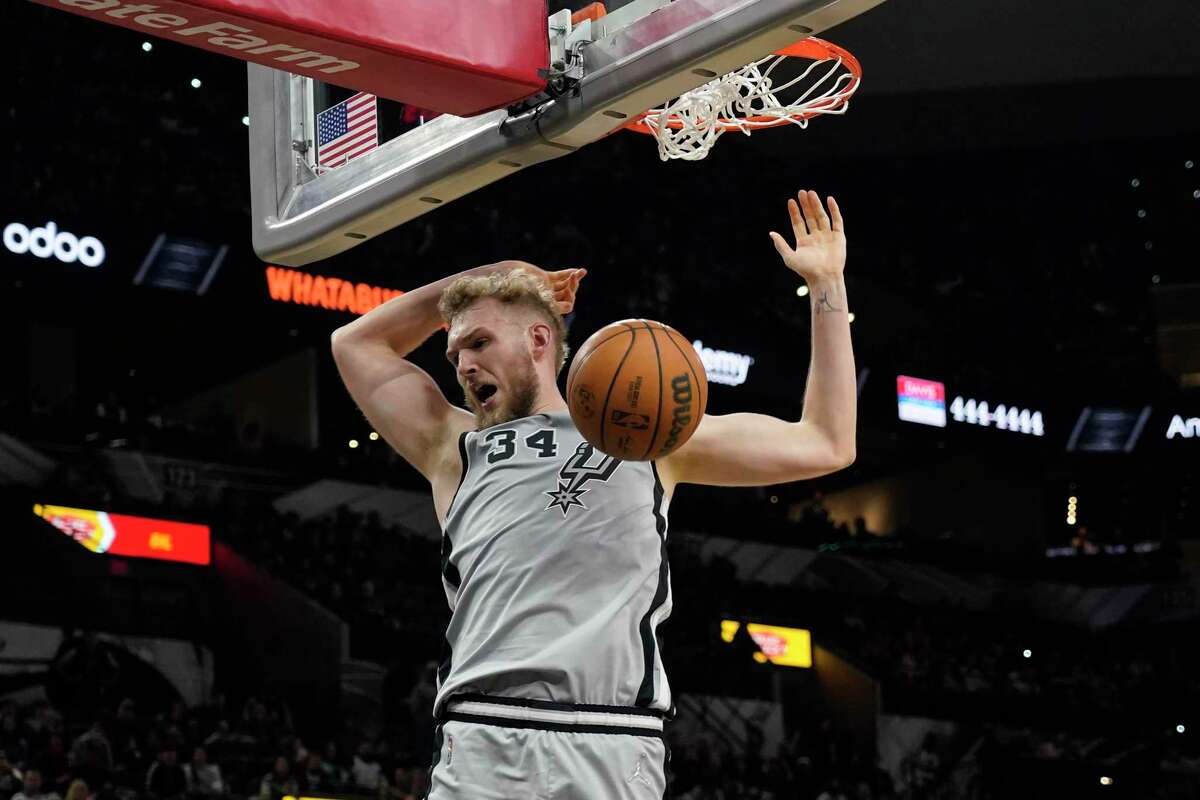 San Antonio Spurs’ Jock Landale (34) dunks against the Indiana Pacers during the second half of an NBA basketball game in San Antonio, Saturday, March 12, 2022.