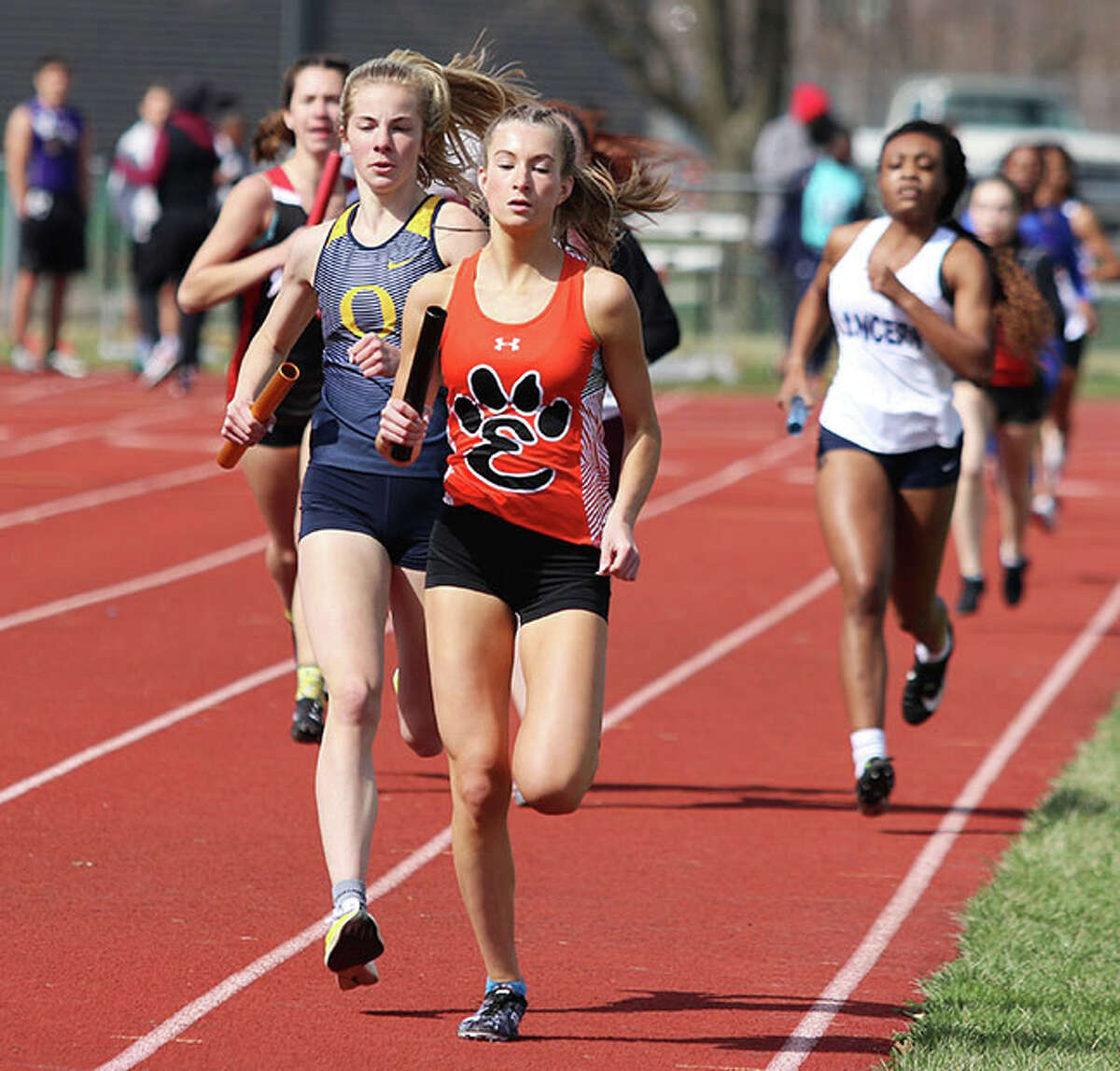 Edwardsville's Maya Lueking runs on the lead with O'Fallon's Peyton Schieppe off her shoulder in the opening lap of the 4x800 relay Friday at the Southwestern Illinois Relays at Winston Brown Track and Field Complex in Edwardsville. On Saturday, Lueking ran a leg with three different teammates in the 4x800 and placed fourth at the Top Times state meet in Bloomington.