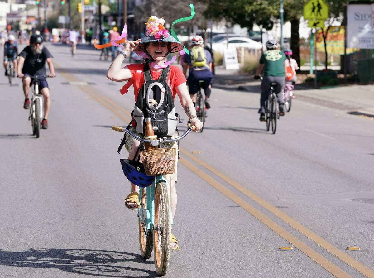 With her Fiesta hat blowing in the breeze, Leigh Anne Lester and her dog Noli ride along S. St. Mary's St. during Sunday's bi-annual Siclovia event that turns city streets into a safe place for bicyclists.