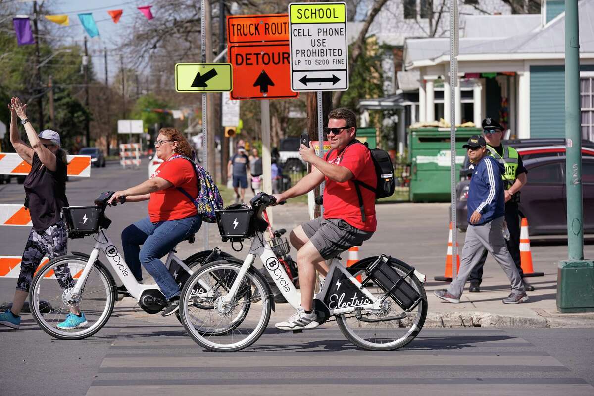 A man on an electric bike takes pictures along South St. Mary’s Street during the spring 2022 Síclovía event. The fall event is being held Sunday.