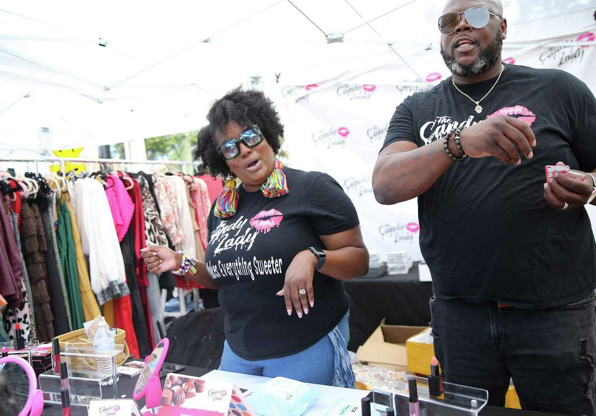 The Candy Lady owners Brandi and Brian Davis of Dallas talk to shoppers during the Turkey Leg Hut annual festival in Houston on Sunday, March 27, 2022. The business owners started in January 2020, and have been happy to have the festivals back to sell their merchandise.