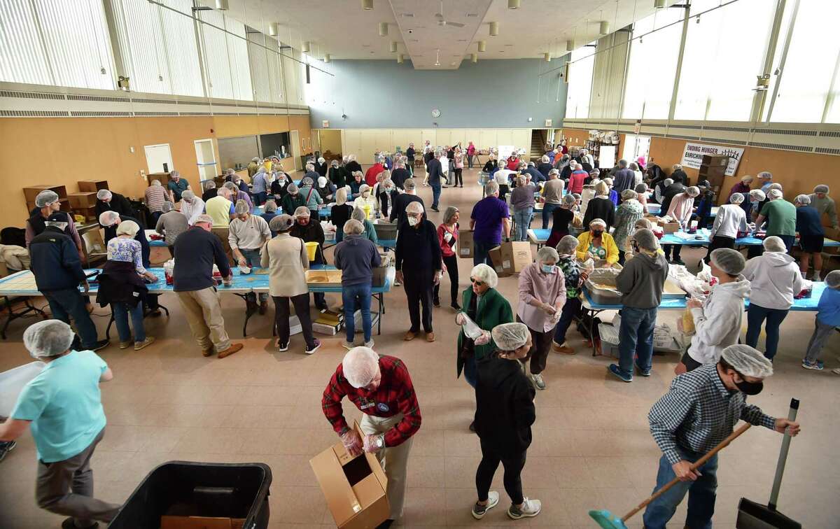 As many as 200 volunteers work to prepare meals during an emergency "Pack-A-Thon" event at Christ Church Greenwich in Greenwich, Conn., on Saturday March 26, 2022. The volunteers worked to reach the goal of providing 36,000-plus packages of nutritious meals for refugees on the border of Poland. The meals will be shipped to Poland in coordination with the Ukrainian Cultural Center in New Jersey.