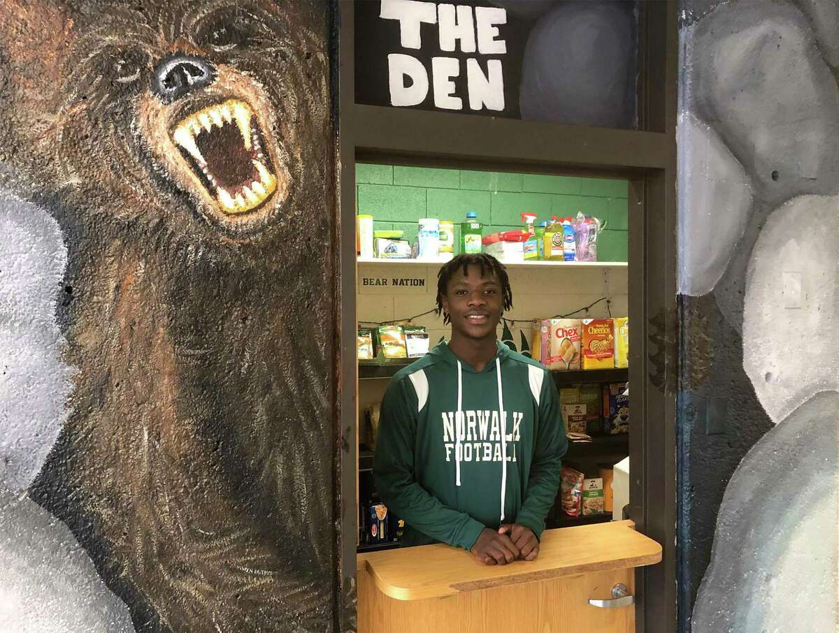 Norwalk's Jeremiah Simeon at the Norwalk High School Food Pantry in "The Den" area of the school's lobby. Simeon, a senior, helped establish the food pantry as part of his work with SAVE, Inc.
