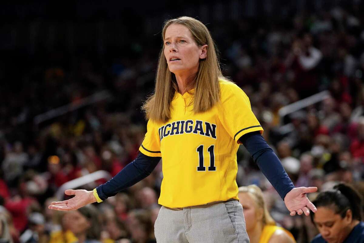 Michigan women's basketball head coach Kim Barnes Arico wears the No. 11 that her late brother Chris wore at the University at Albany. (AP Photo/Jeff Roberson)