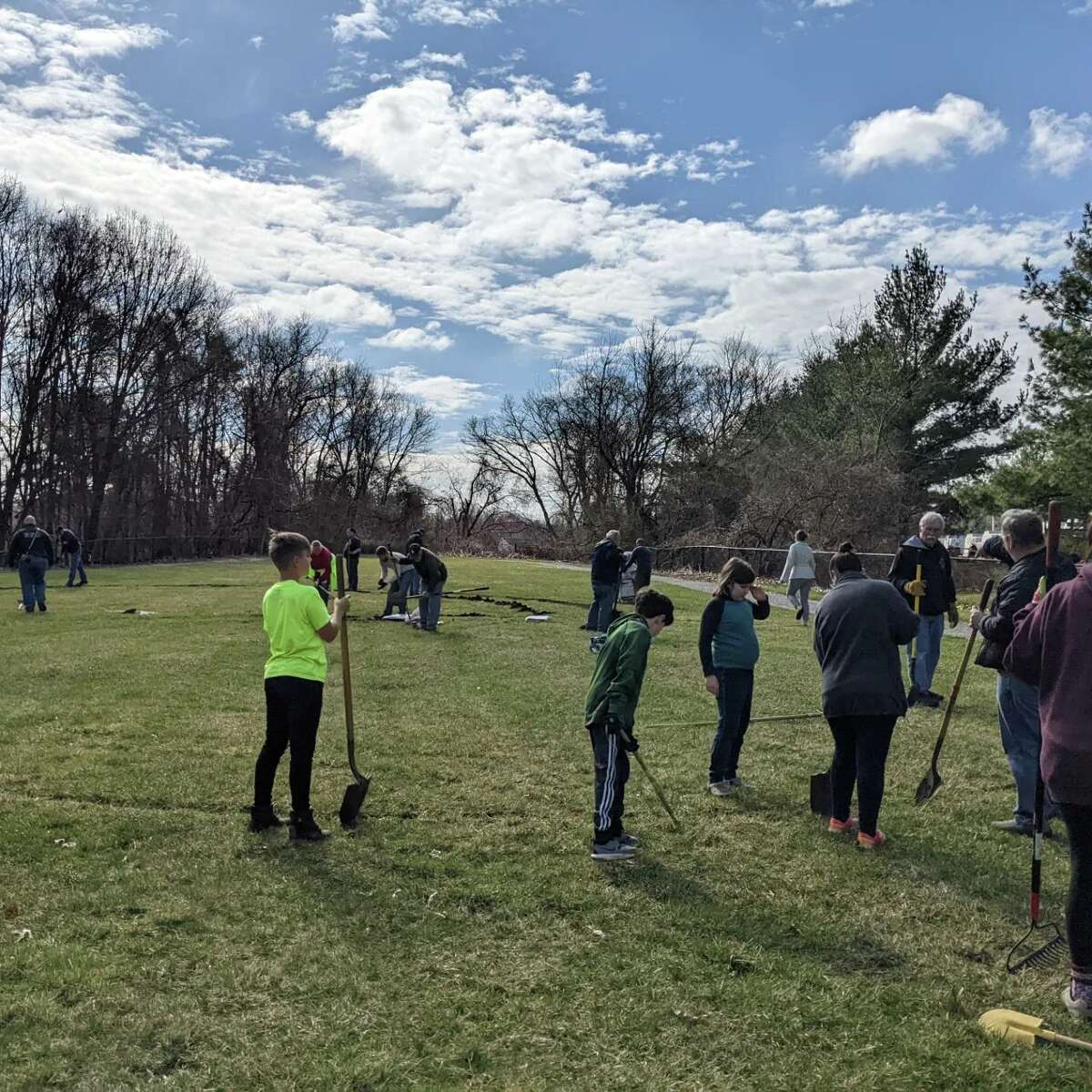 Volunteers help repair a field at Make-A-Wish Connectict, 56 Commerce Dive, Trumbull, on March 26, 2022