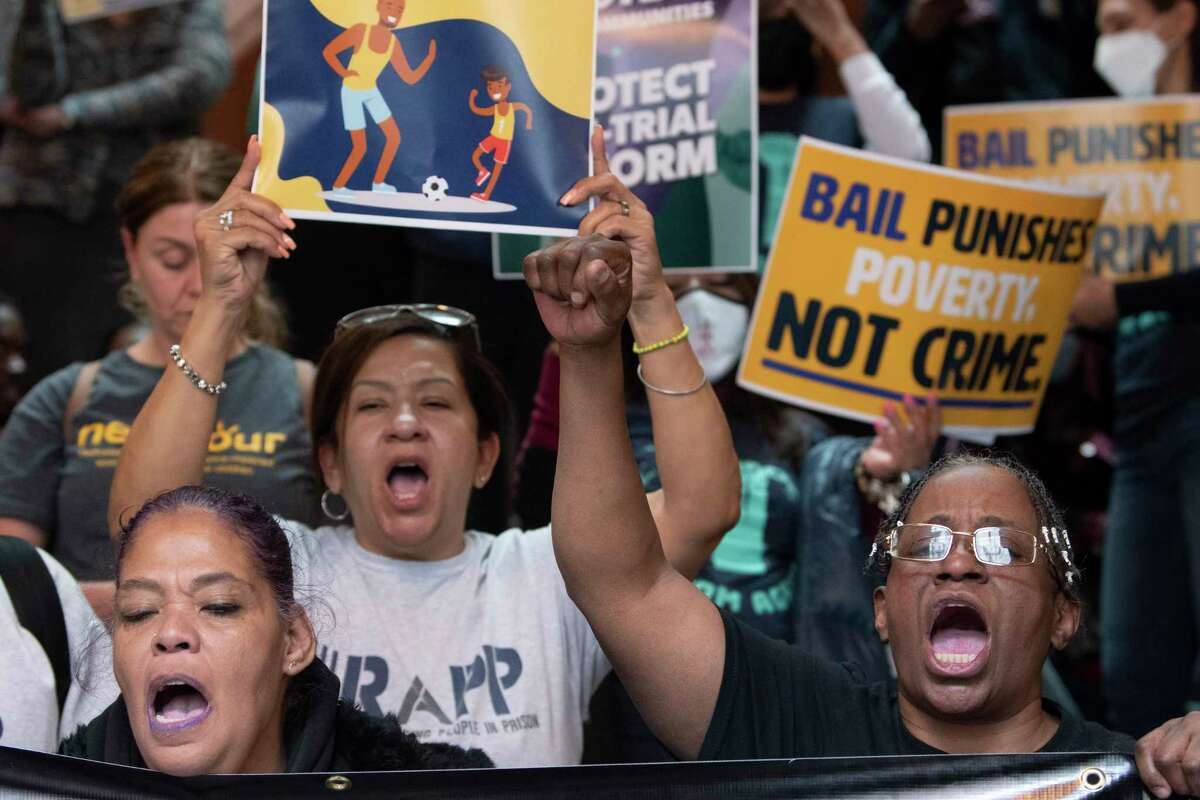 Demostrators hold signs during a rally in favor of the 2019 Bail Reform Bill held at the New York State Capitol on Monday, March 28, 2022 in Albany, N.Y.