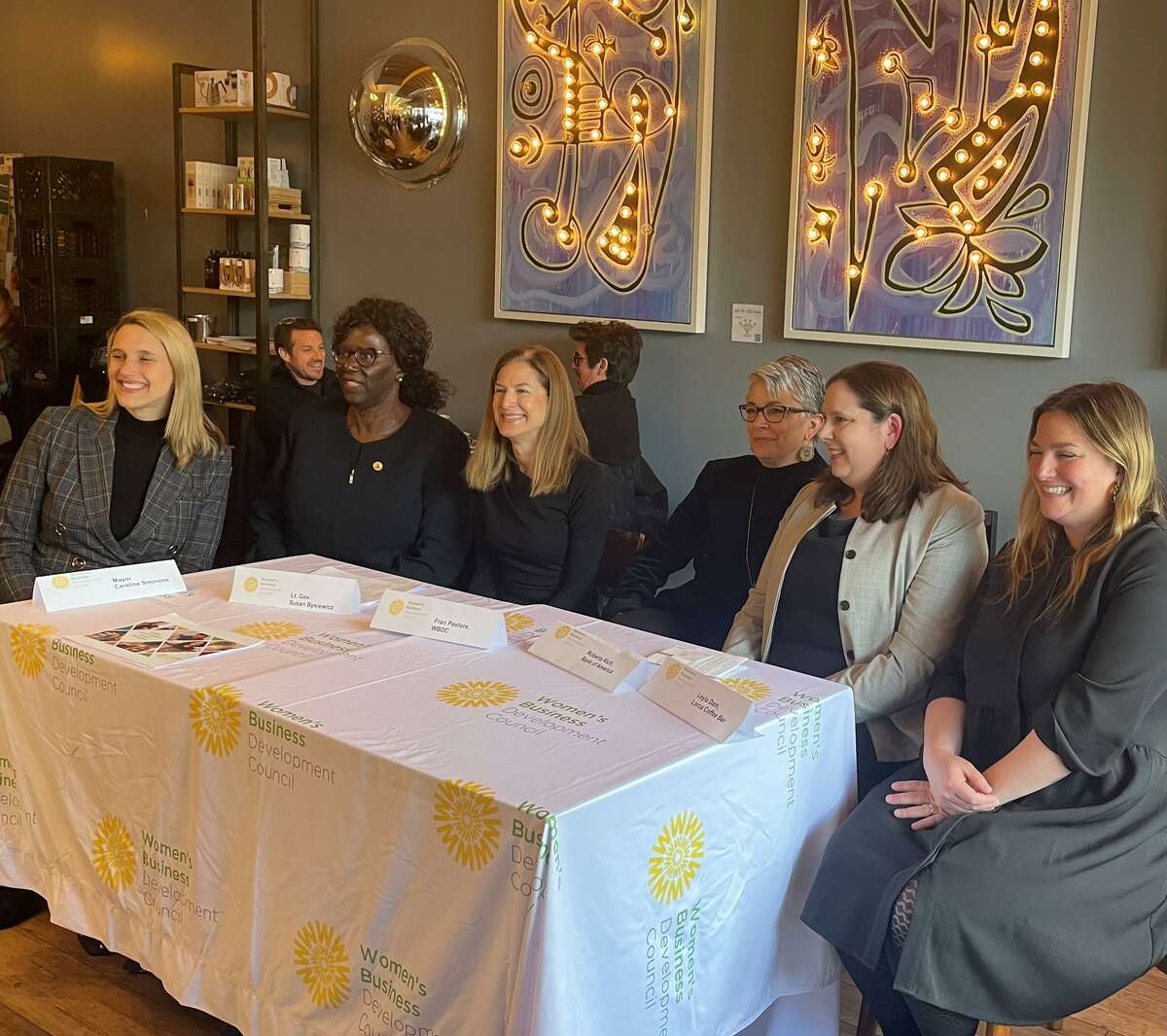 From left, Stamford Mayor Caroline Simmons, state Sen. Patricia Billie Miller, D-Stamford, Lt. Gov. Susan Bysiewicz, Women’s Business Development Council founder and CEO Fran Pastore, Bank of America consumer bank market leader Roberta Rich and Lorca Coffee Bar owner Leyla Dam gather at Lorca in downtown Stamford, Conn., on Monday, March 28, 2022, to discuss the WBDC’s Equity Match Grant Program.