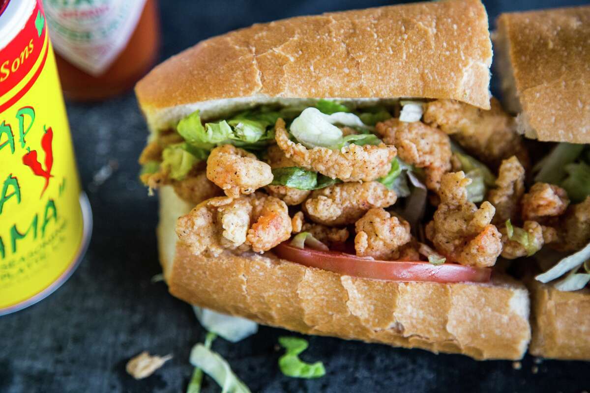 Ragin' Cajun's fried crawfish tail po'boy is a mess of hot mudbug meat stuffed into a dressed French baguette.