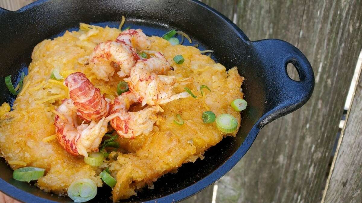 Cast Iron Cheesy Crawfish Cornbread Made to Order at Piggy's Kitchen & Bar is a hot skillet of cornbread stuffed with crawfish, peppers, cheese, Creole seasoning and butter.
