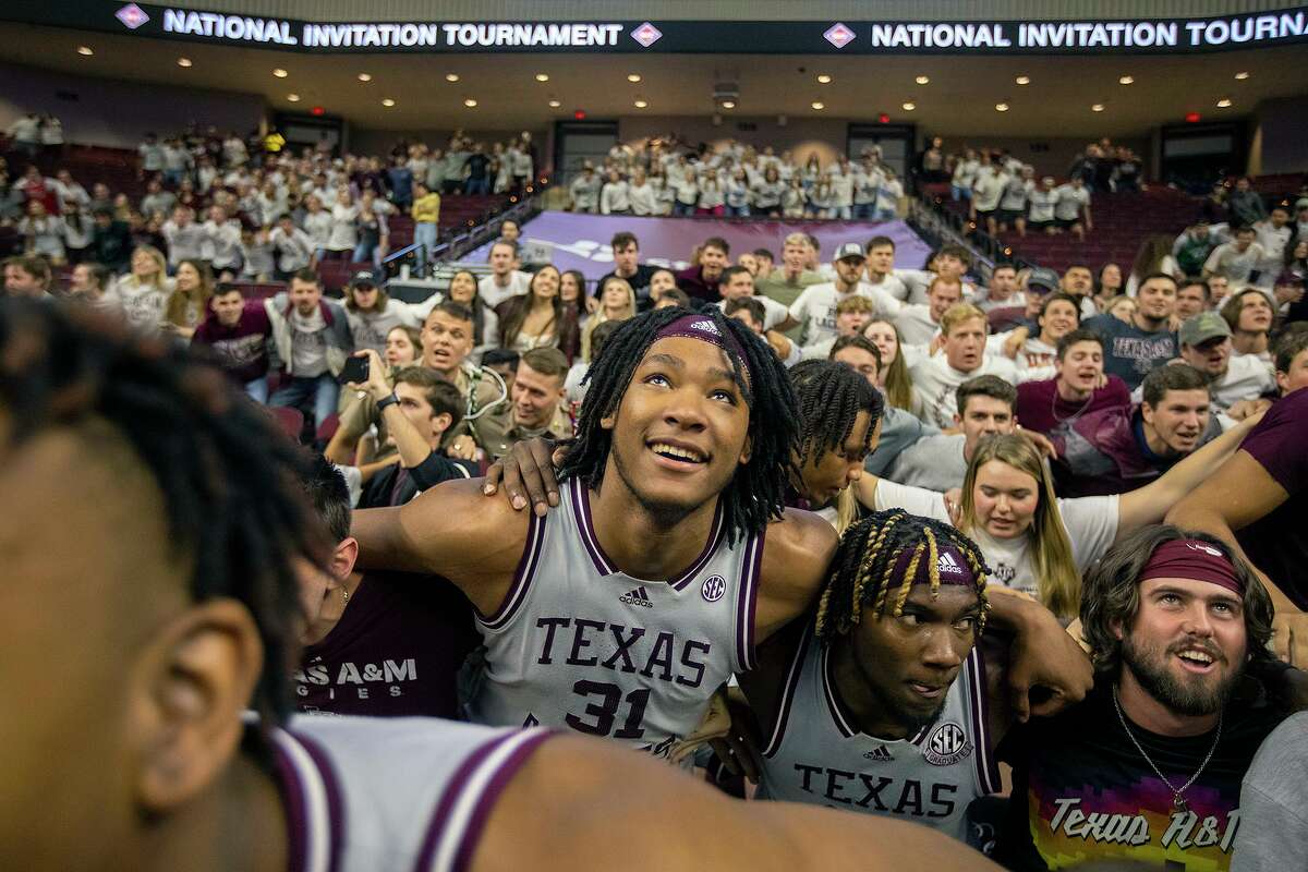 Texas A&M’s Javonte Brown (31) and Tyrece Radford take part in the Aggie War Hymn with fans following their victory in an NCAA college basketball game against Wake Forest in the third round of the NIT in College Station on Wednesday, March 23, 2022.