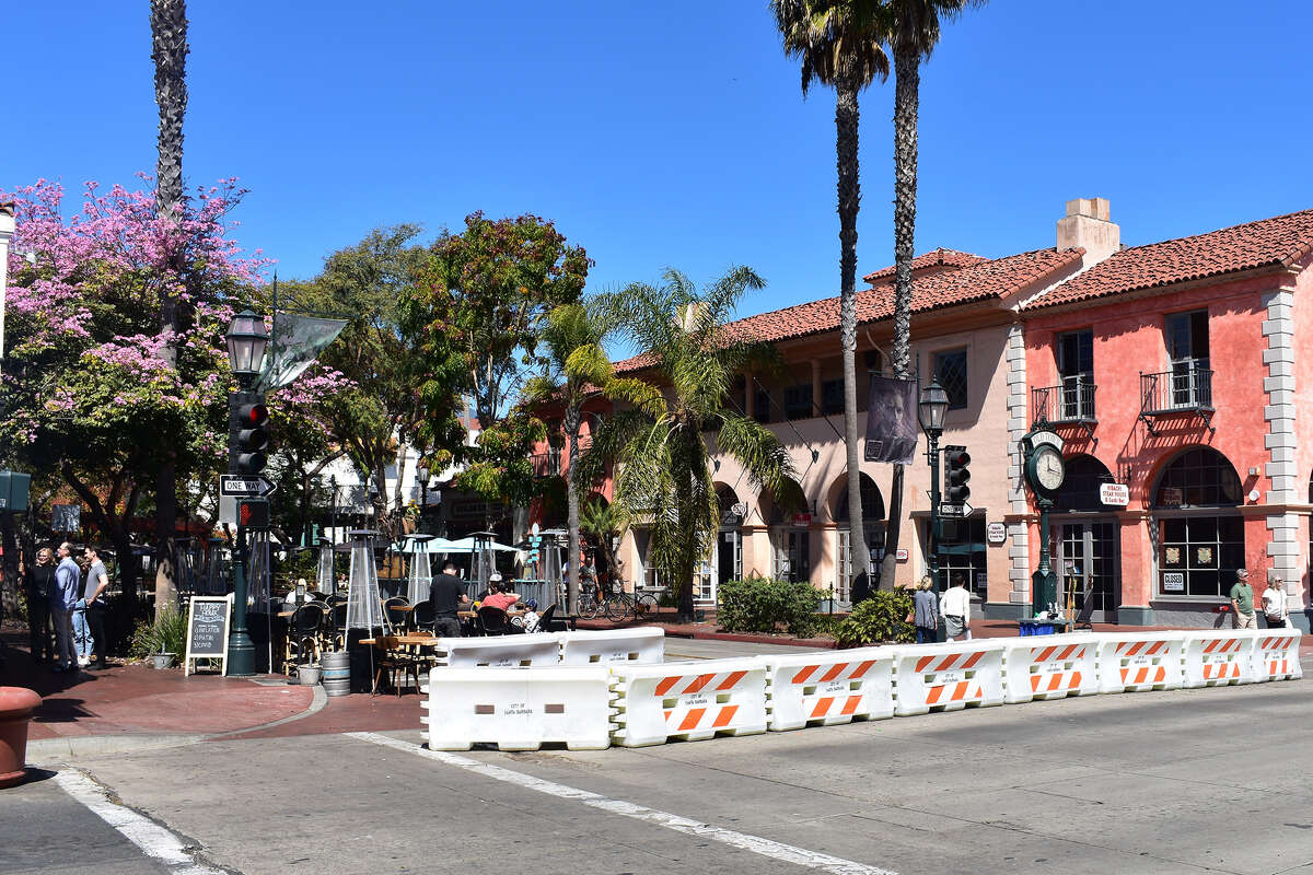 Temporary barriers block off the 500 block of State Street to traffic in downtown Santa Barbara. The city is working on a permanent plan to keep a 10-block section of the arterial street open for pedestrian traffic only. 