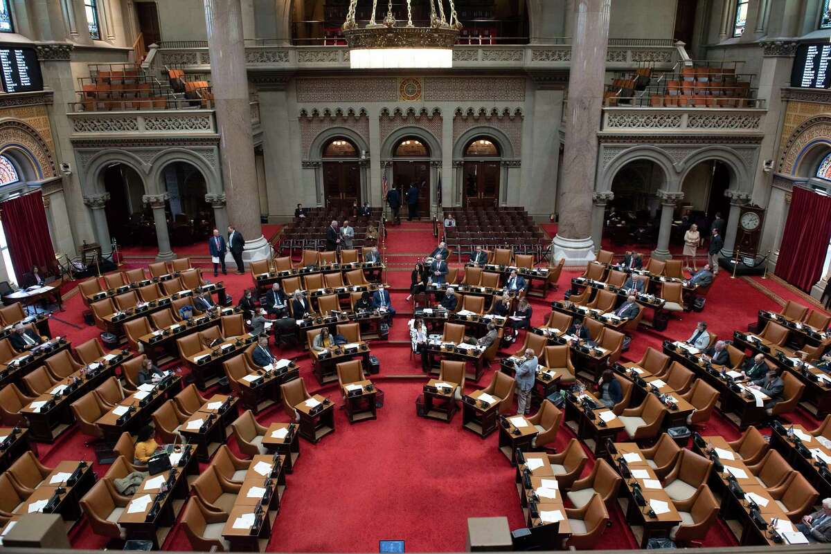 Members of the Assembly talk about the Debt Service Fund during session in the Assembly Chamber at the New York State Capitol on Monday, March 28, 2022 in Albany, N.Y.