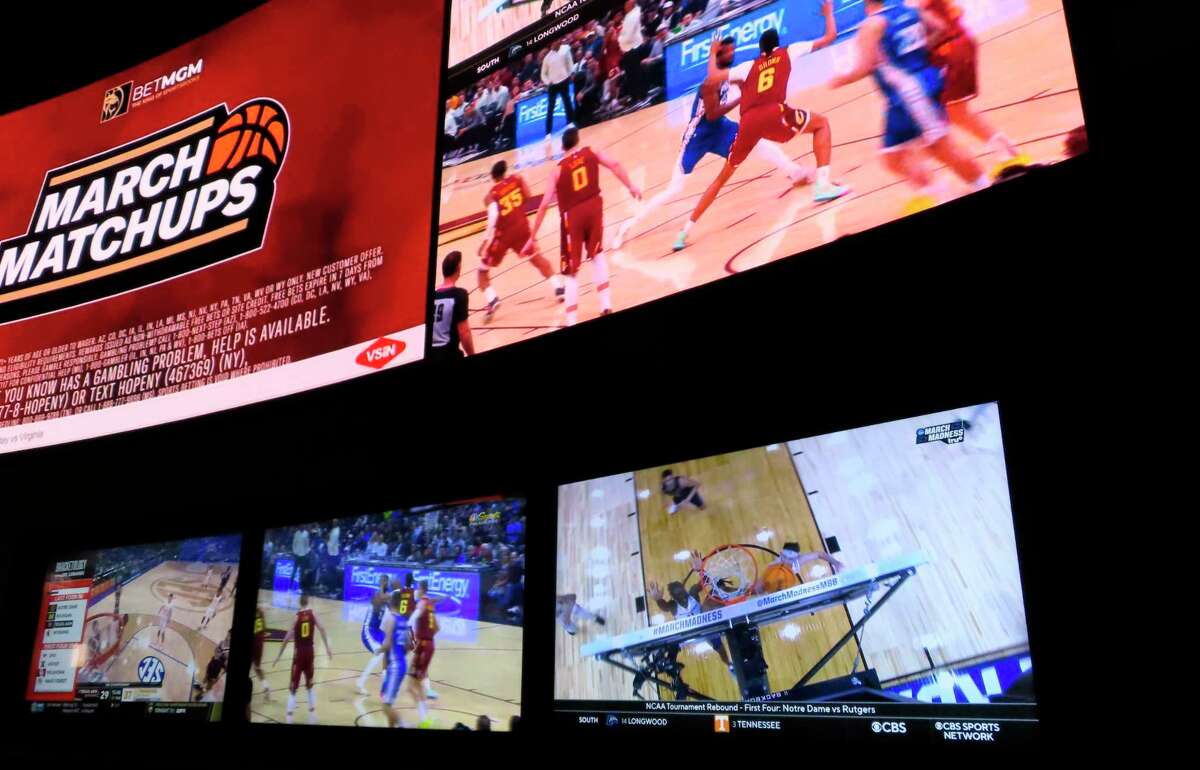 Giant video screens line the walls of the sportsbook at the Borgata casino in Atlantic City, N.J., on Thursday, March 17, 2022, the first day of March Madness NCAA college basketball tournament.
