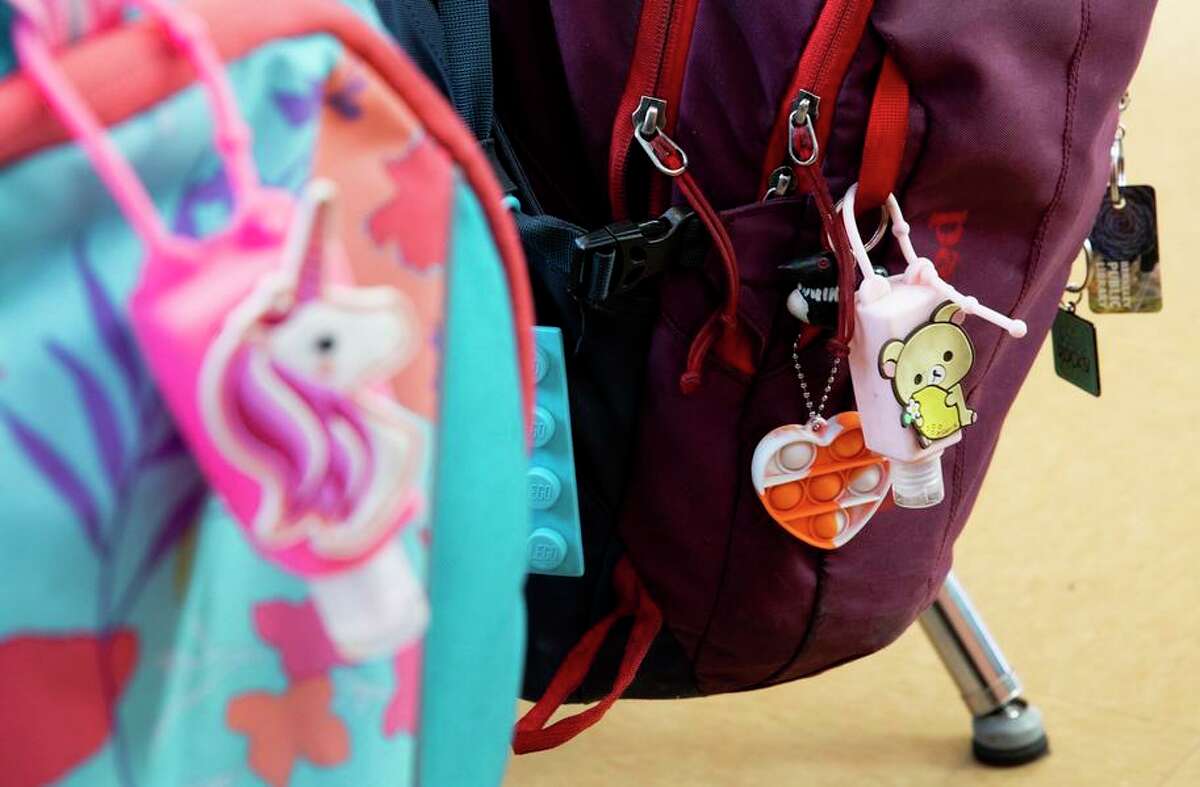 Hand sanitizer is seen hanging from backpacks in Yusef Aulett's fourth grade class at Ruth Acty Elementary School in Berkeley, Calif. 