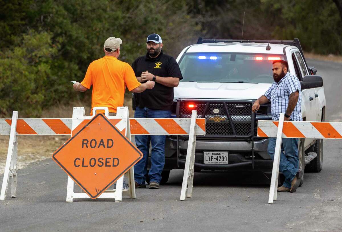 A man talks to Medina County Deputies on Monday, March 28, 2022, at a road block on County Road 2615 as they try to determine whether they can get to his home near the Das Goat fire.