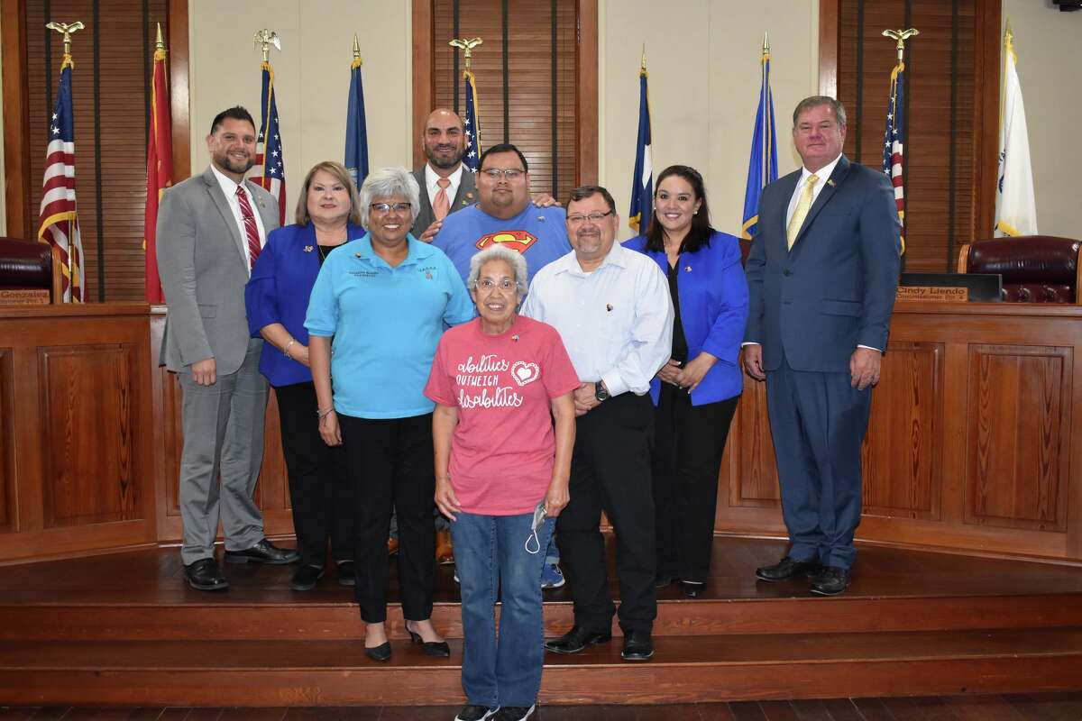 Members of the Webb County Commissioner's Court posed with the Orduna family during the Monday Commissioner Court Meeting that proclaimed April 2022 Autism Awareness Month.