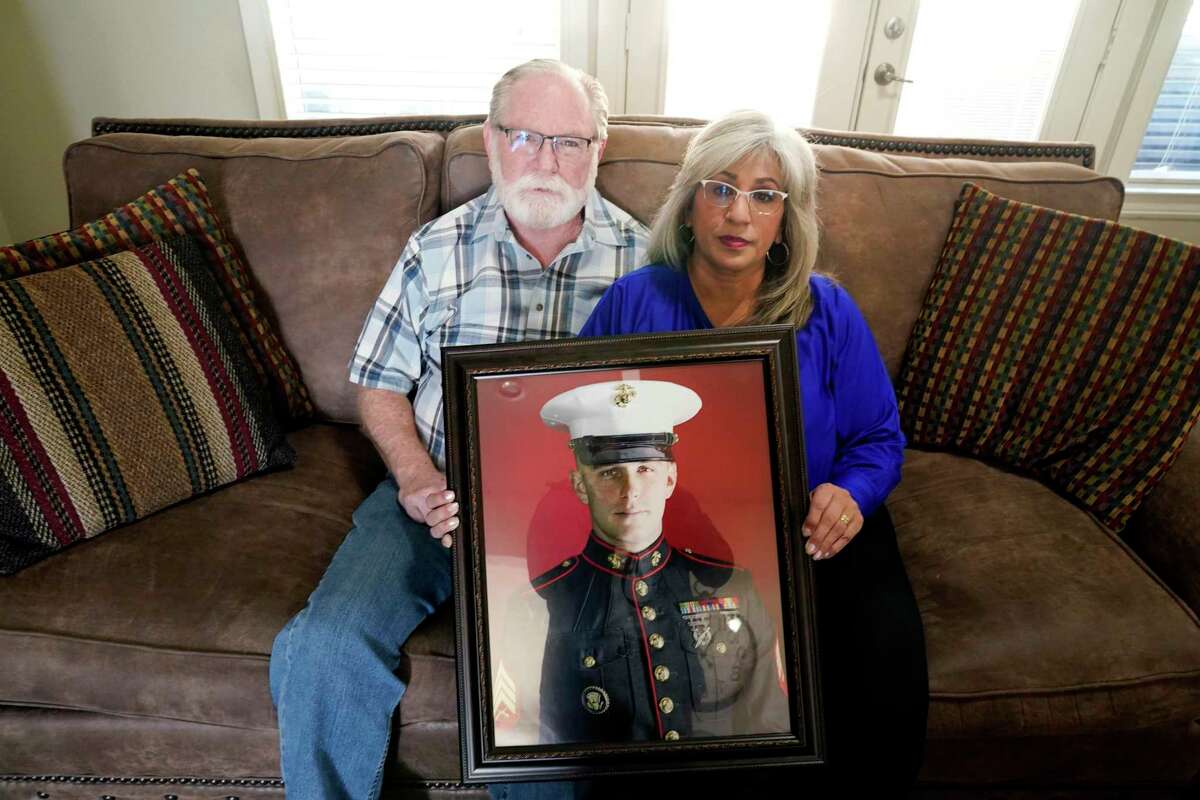 Joey and Paula Reed of Fort Worth with a portrait of their son, Marine veteran and Russian prisoner Trevor Reed.