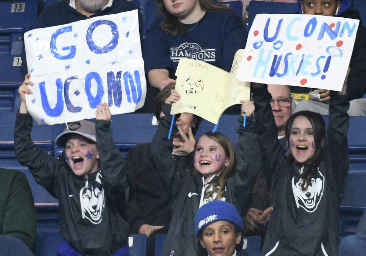 UConn fans cheer as the Huskies warm up before the NCAA women's basketball tournament Elite Eight matchup between No. 2 UConn and No. 1 NC State at Total Mortgage Arena in Bridgeport, Conn. Monday, March 28, 2022.