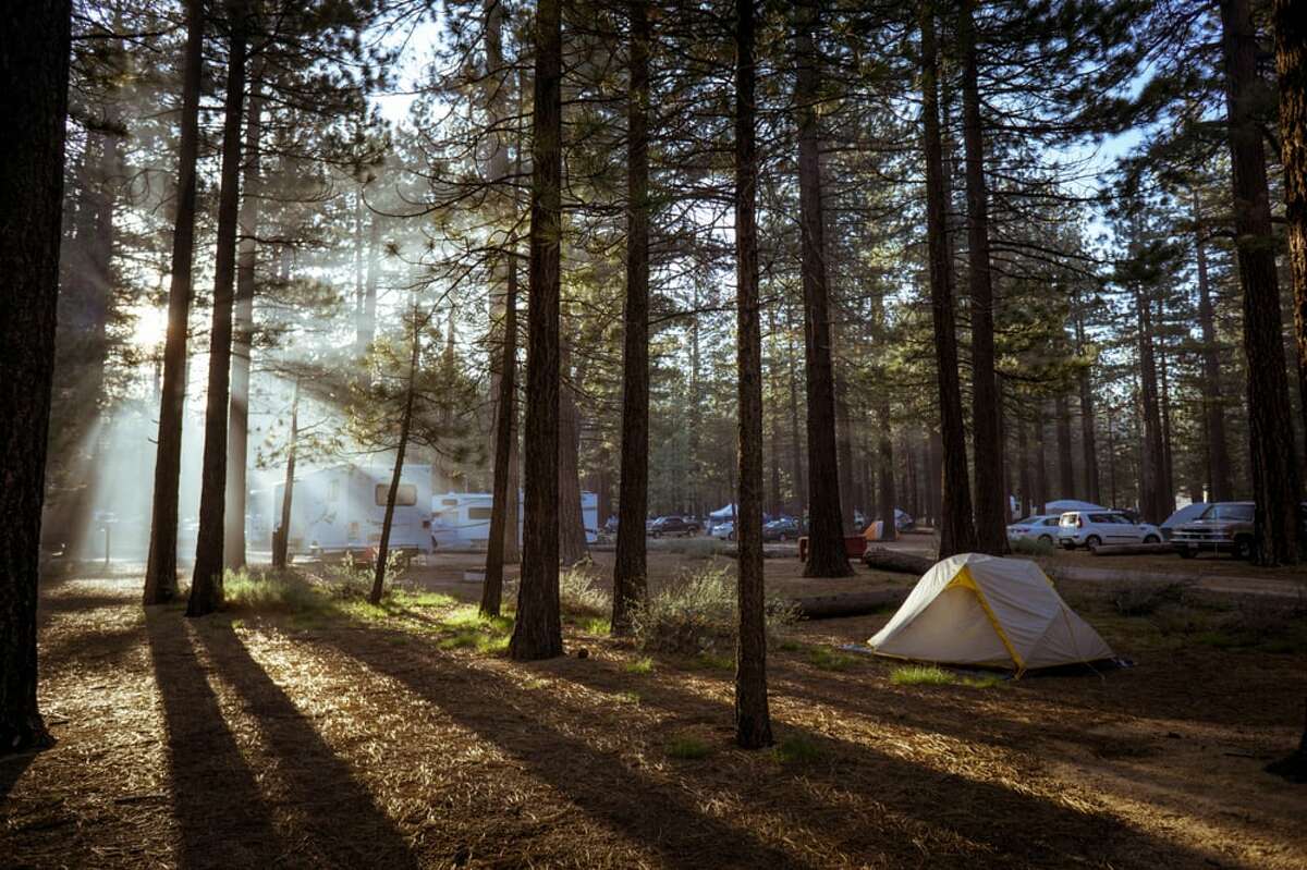 The sun peeks through the trees at Campground by the Lake.