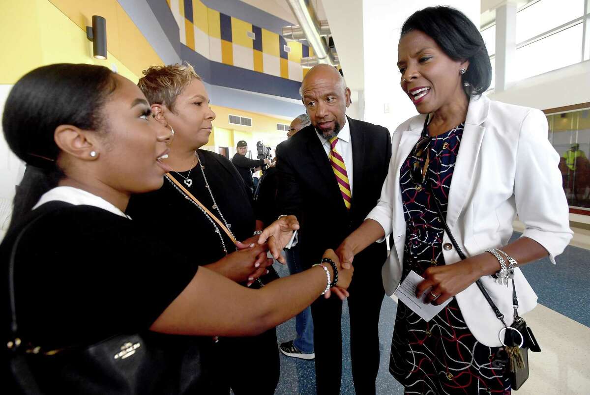 Beaumont United new head football coach Darrel Colbert, Sr., introduces Superintendent Dr. Shannon Allen to his family before an introductory press conference Monday at the Jackson Center. Photo made Monday, March 28, 2022 Kim Brent/The Enterprise