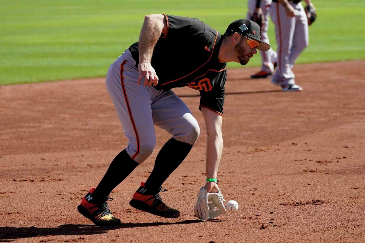 San Francisco Giants' Evan Longoria runs drills during spring training baseball workouts, Tuesday, March 15, 2022, in Scottsdale, Ariz. (AP Photo/Matt York)