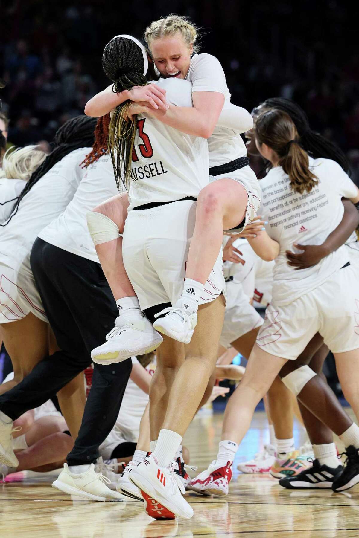 WICHITA, KANSAS - MARCH 28: Hailey Van Lith #10 of the Louisville Cardinals celebrates with Merissah Russell #13 after the 62-50 win over the Michigan Wolverines in the Elite Eight round game of the 2022 NCAA Women's Basketball Tournament at Intrust Bank Arena on March 28, 2022 in Wichita, Kansas. (Photo by Andy Lyons/Getty Images)