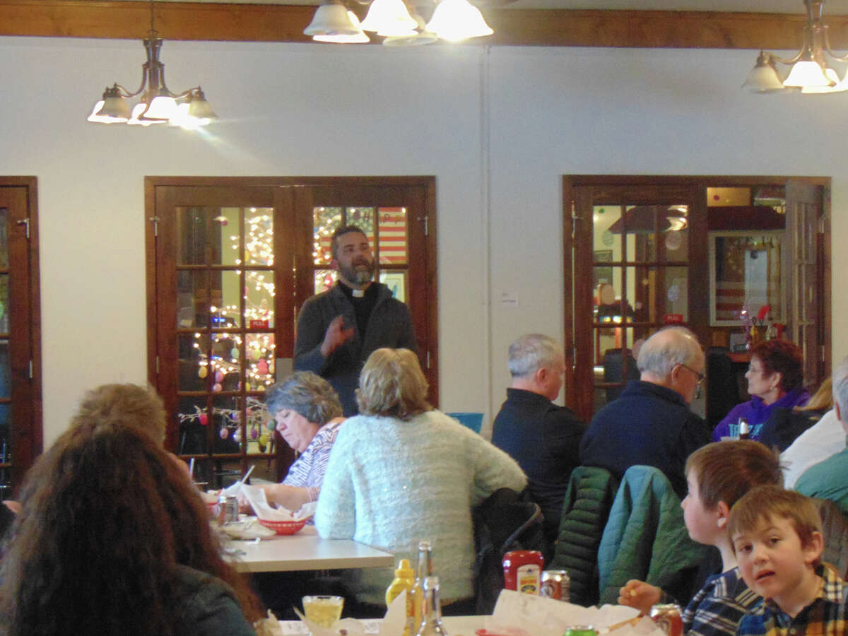 Fr. Matt Barnum explains church teachings and theology to nearly 100 people at AMVETS.