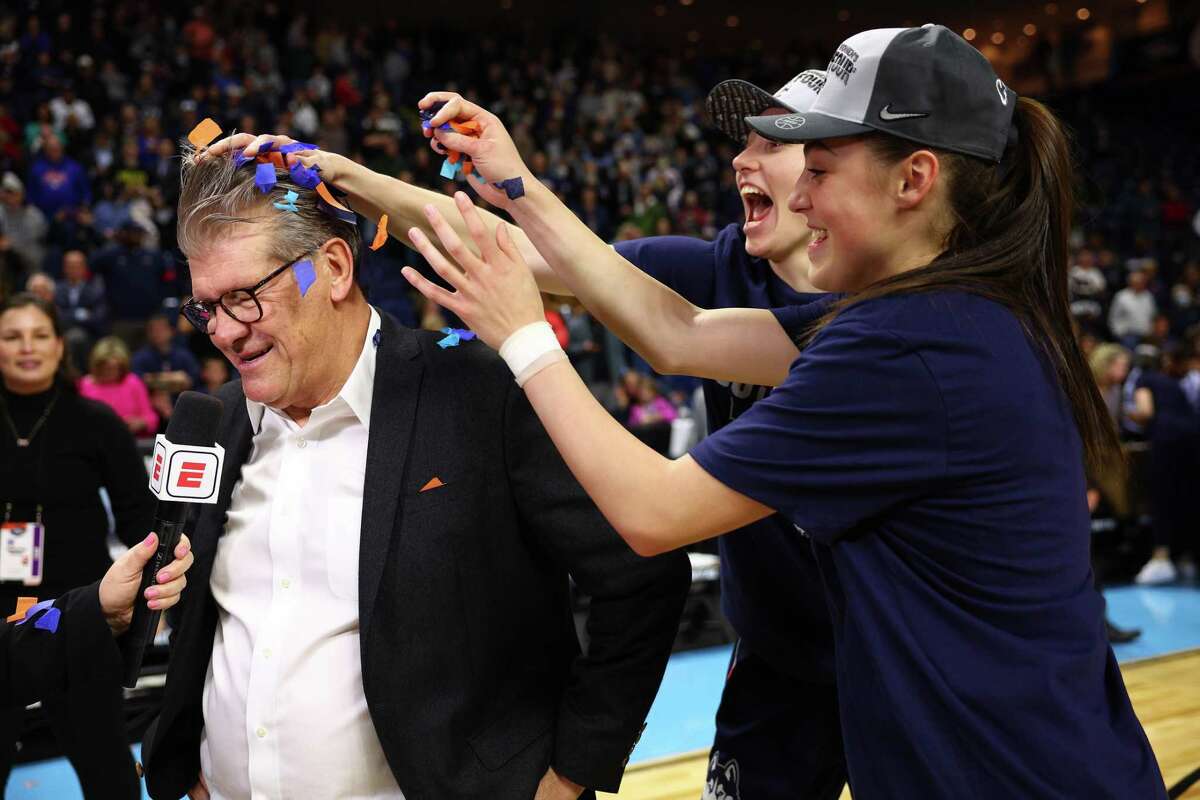 BRIDGEPORT, CONNECTICUT - MARCH 28: UConn Huskies players dump confetti on head coach Geno Auriemma after defeating the NC State Wolfpack 91-87 in 2 OT in the NCAA Women's Basketball Tournament Elite 8 Round at Total Mortgage Arena on March 28, 2022 in Bridgeport, Connecticut. (Photo by Elsa/Getty Images)