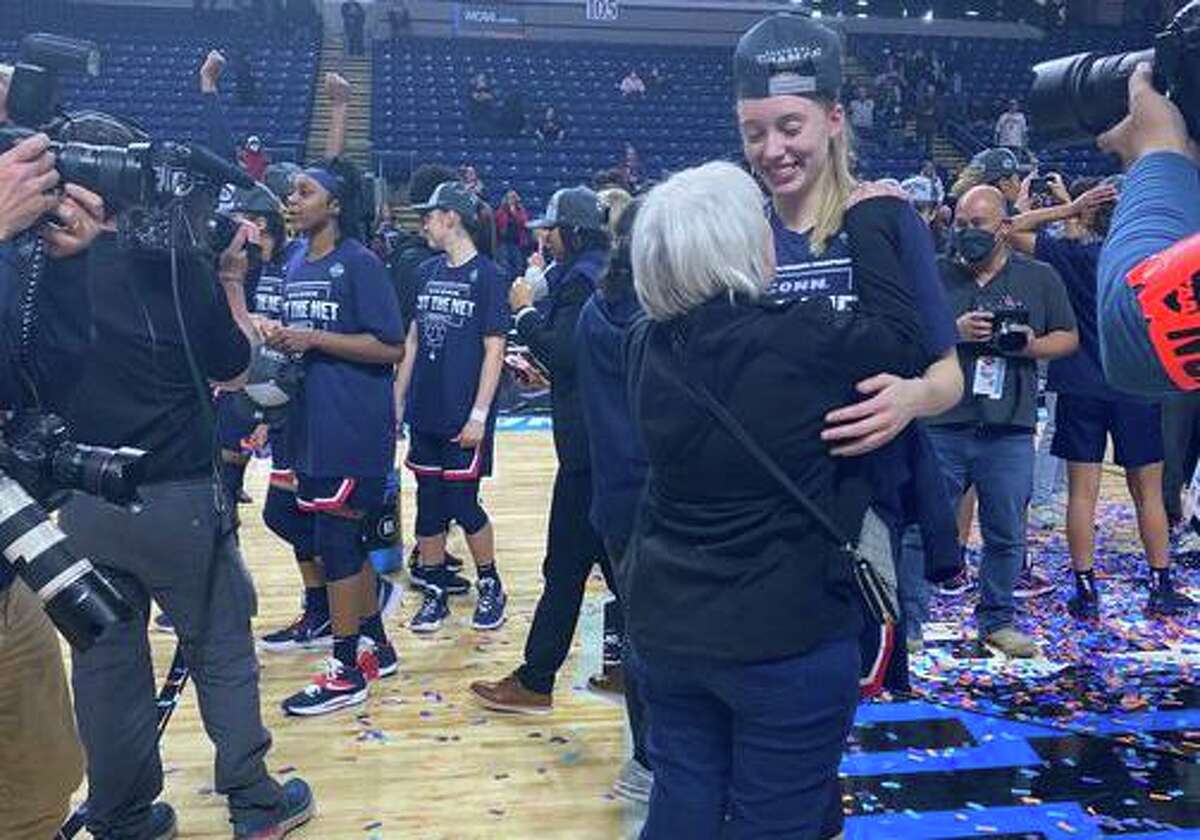 UConn women's basketball player Paige Bueckers embraces her grandmother, Joann Dettbarn, after the Huskies defeated NC State Monday, March 29, 2022. Photo by Maggie Vanoni