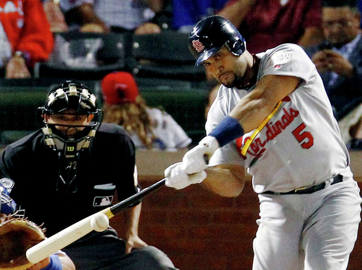 In this file photo, St. Louis Cardinals' Albert Pujols hits a solo home run during the ninth inning of Game 3 of baseball's World Series against the Texas Rangers in Arlington, Texas, in this Saturday, Oct. 22, 2011, file photo. Pujols has returned to the Cardinals, finding a home in the place where he became one of baseball's most powerful sluggers. 