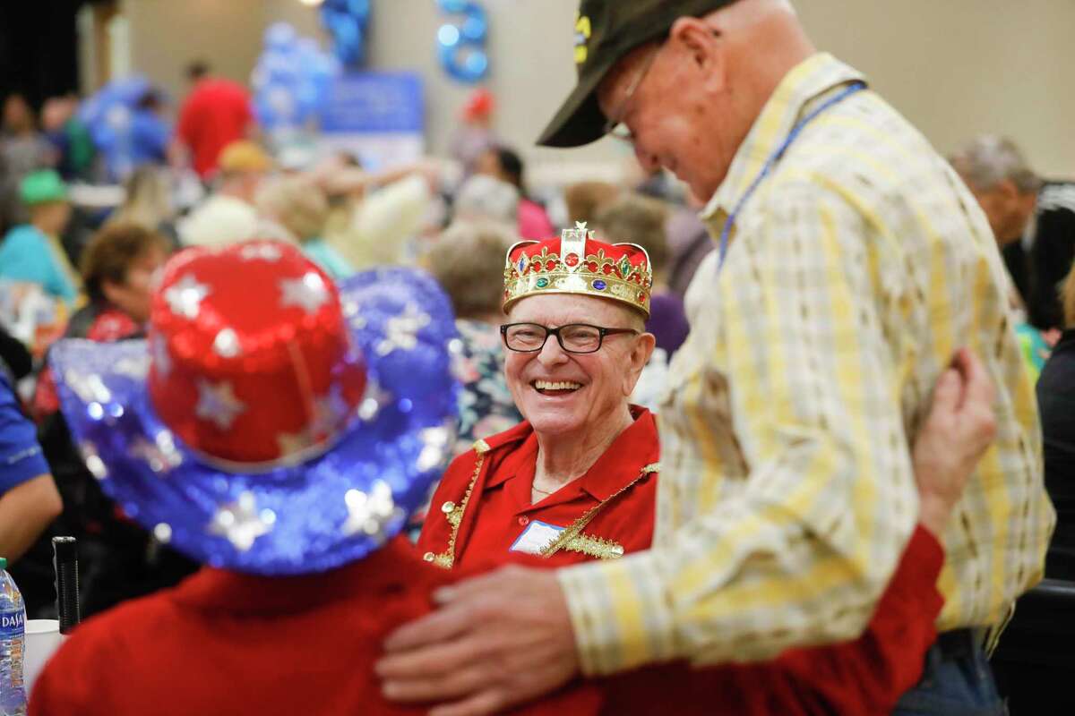 Ted Guest, center, laughs as he visits with friends during Senior Citizen’s Day at the Montgomery County Fair and Rodeo, Tuesday, March 29, 2022, in Conroe. The event returned to the fair after a two year pandemic pause.
