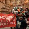 Demonstrators urging Gov. Kathy Hochul for affordable housing for all are seen protesting in the New York State Capitol on Tuesday, March 29, 2022 in Albany, N.Y.