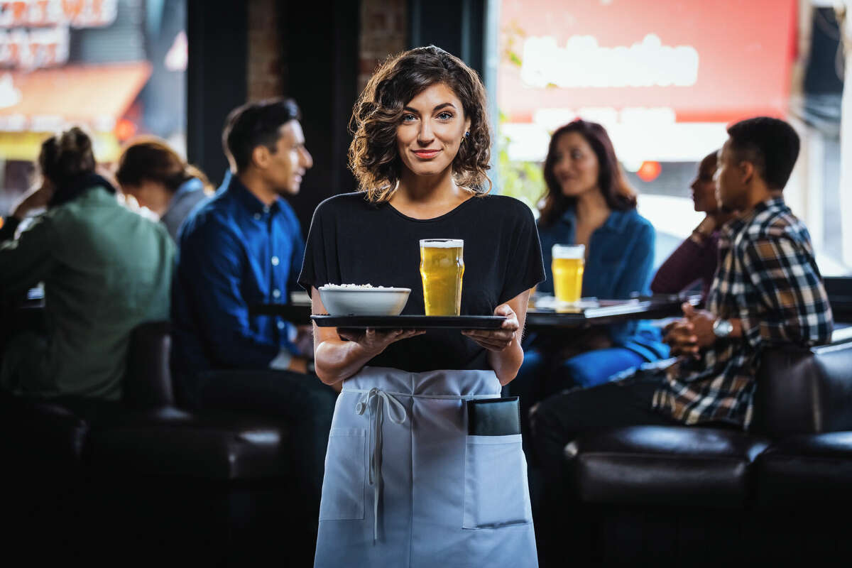 A waitress serves beer at a bar in this file photo.