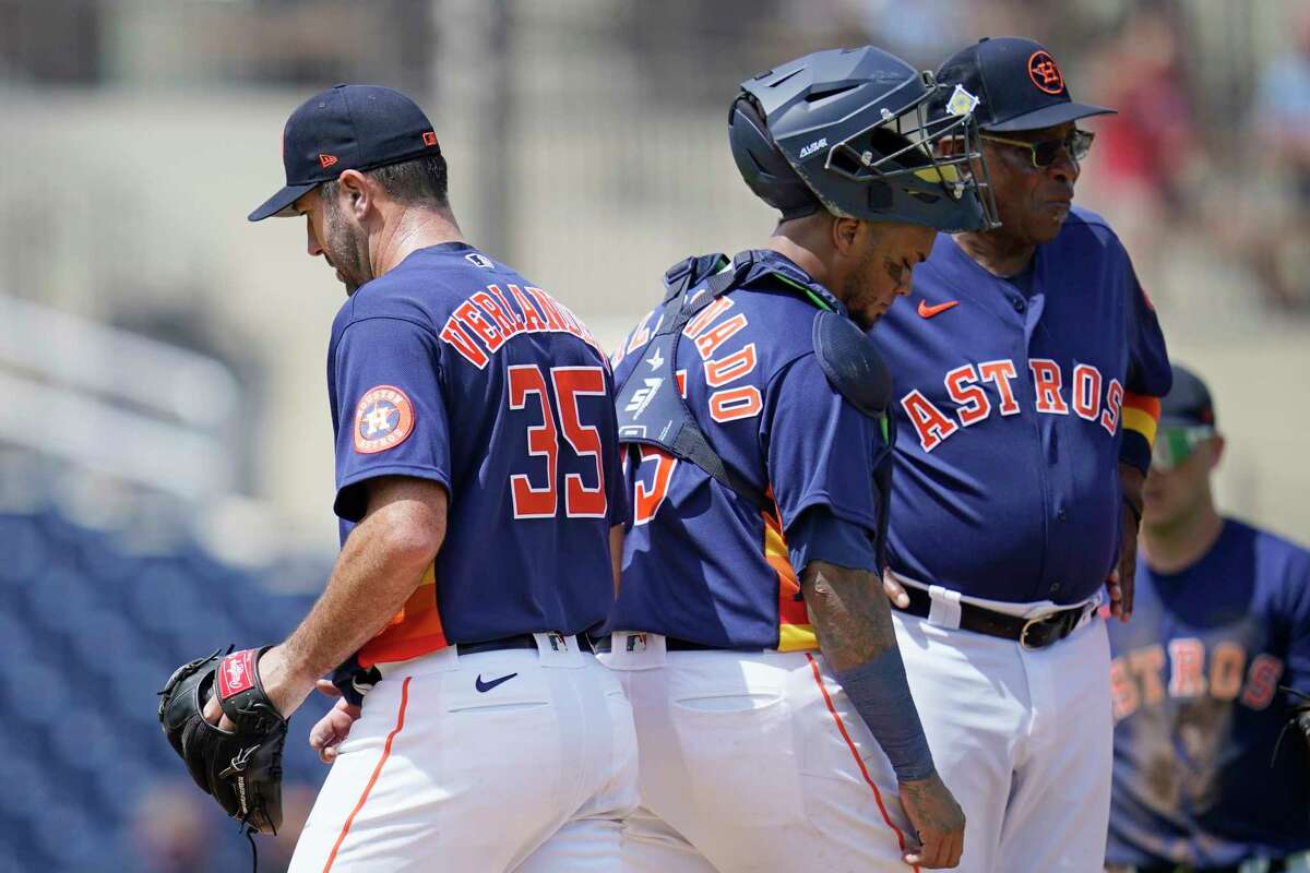 Houston Astros starting pitcher Justin Verlander (35) is taken out of the game in the third inning of a spring training baseball game against the St. Louis Cardinals, Wednesday, March 23, 2022, in West Palm Beach, Fla. Catcher Martin Maldonado and manager Dusty Baker Jr. are at right. (AP Photo/Sue Ogrocki)