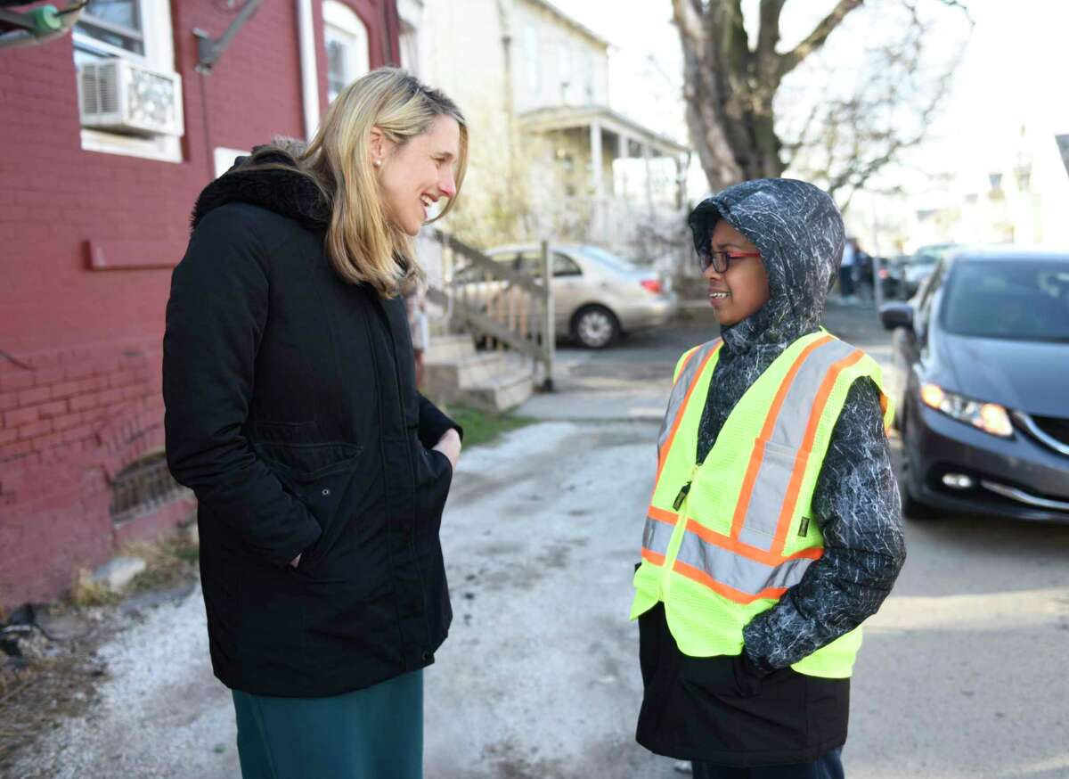 Stamford Mayor Caroline Simmons chats with Riley Jones, a sixth grader at Stamford Charter School for Excellence, at the location where a traffic signal cabinet will be relocated in Stamford, Conn. Tuesday, March 29, 2022. Jones, 11, notified the Citizen Services and Transportation, Traffic, and Parking Department that the sidewalk at the intersection of Lockwood Avenue and Cove Road does not allow enough room for handicapped residents to safely use the sidewalk. The large signal box is now being relocated one block away to allow ADA access of the sidewalk.