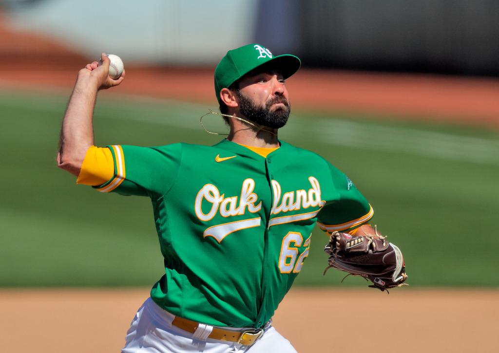 Oakland Athletics relief pitcher Lou Trivino wipes sweat from his forehead  after allowing a walk against the Texas Rangers during the ninth inning of  a baseball game in Oakland, Calif., Friday, July