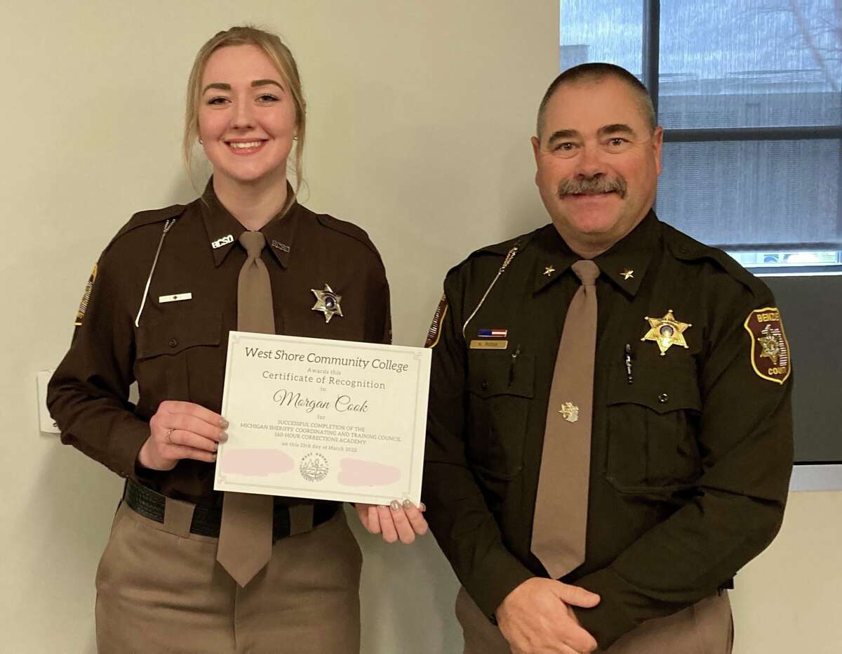 Benzie County Sheriff's Office Deputy Morgan Cook, shown here with Benzie County Sheriff Kyle Rosa, graduated from the Corrections Academy at West Shore Community College in March. 