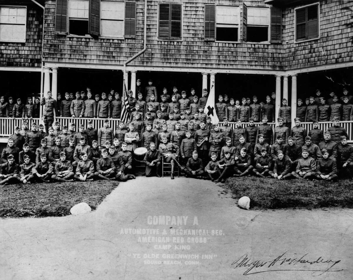 Walt Disney (top row, center, dwarfed by two men standing to his immediate right) in a photograph of his unit at Camp King, Sound Beach, Connecticut, circa early to mid-November 1918. 
