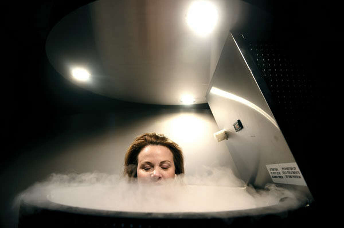 Practice manager Robyn Calitri demonstrates a cryotherapy sauna at Grace Medical Aesthetics in Middlebury.