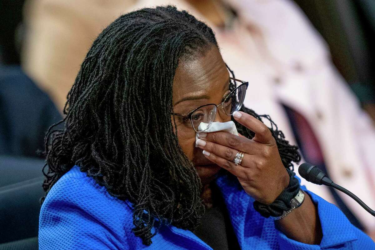 Supreme Court nominee Ketanji Brown Jackson becomes emotional during an impassioned speech by Sen. Cory Booker, D-N.J., during her Senate Judiciary Committee confirmation hearing on Capitol Hill in Washington, Wednesday, March 23, 2022.
