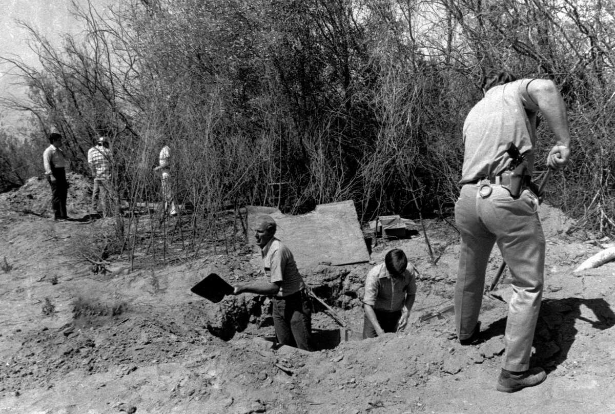 FILE - In this July 17, 1976 photo, members of the Alameda County Crime Lab and FBI are pictured working around the opening to the van where 26 Chowchilla school children and their bus driver were held captive at a rock quarry near Livermore, Calif. California parole commissioners have recommended parole for the last of three men convicted of hijacking a school bus full of children for $5 million ransom in 1976. The two commissioners acted Friday, March 25, 2022, in the case of 70-year-old Frederick Woods.