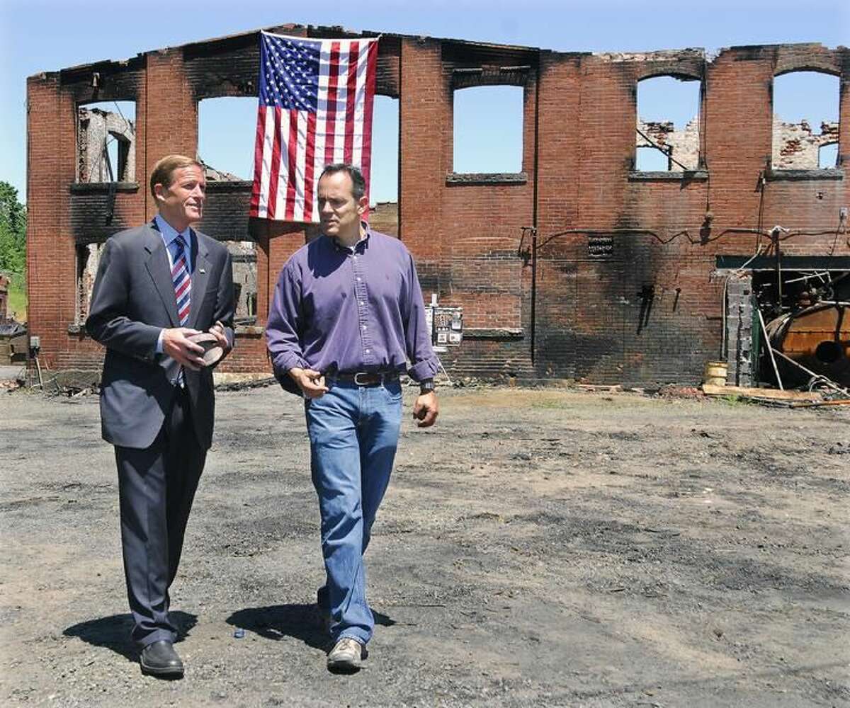 Senator Richard Blumenthal speaks with Matthew G. Bevin, president of the Bevin Brother's Manufacturing, after touring the 180 year old bell factory in late May 2012, after 130 year old structure was destroyed by fire.