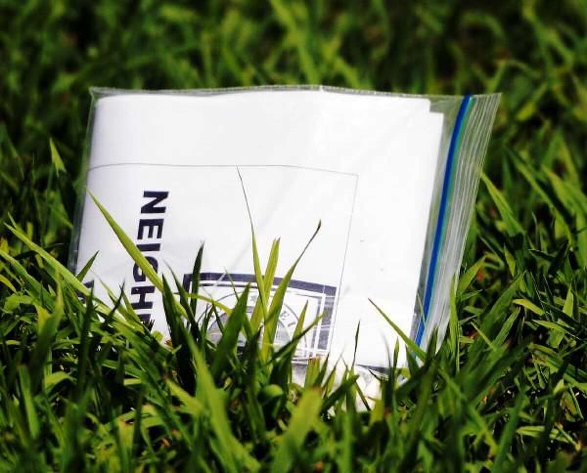 Printed material in a plastic bag on the front lawn at 181 Herbert Avenue in Milford, Connecticut July 9, 2013.
