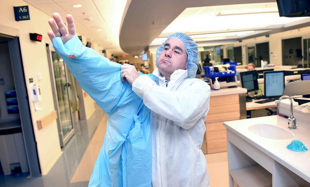 Donald MacMillan, Emergency Management Coordinator at Yale-New Haven Hospital, dons protective gear in the hospital's Emergency Department during a demonstration of protocol for handling cases of Ebola on 10/14/2014.