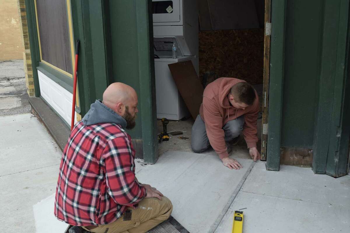 David Johnson (left) and Dylan Brickey renovate a building at 221 W. Morgan St. The two said the building was built in the 1800s and they are renovating it on behalf of Ed Killam, owner of Antiquarius at 701 W. State St.