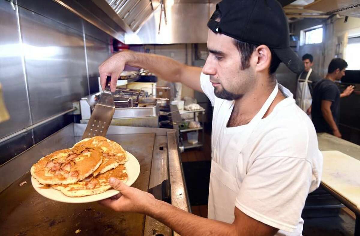 Isaac Cardenos makes pancakes at Cristy's on the Route 1 in Westbrook.