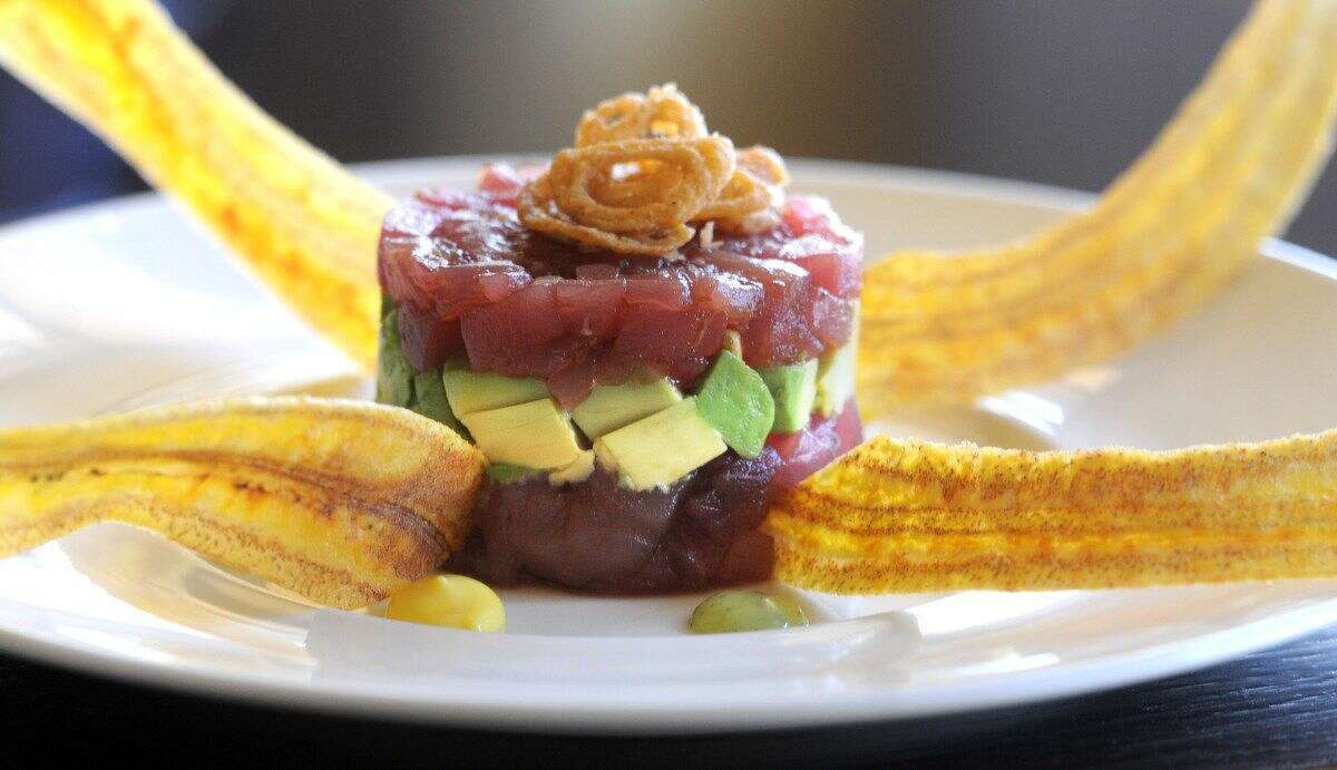 Tuna tartare: Yellowfin tuna with wasabi caviar, avocado, crispy plantain, garnished with crispy shallots.