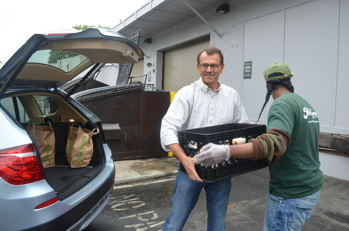 Tom Hauser, Fairfield County site director, picks up a donation from Mrs. Green's Natural Market in New Canaan.