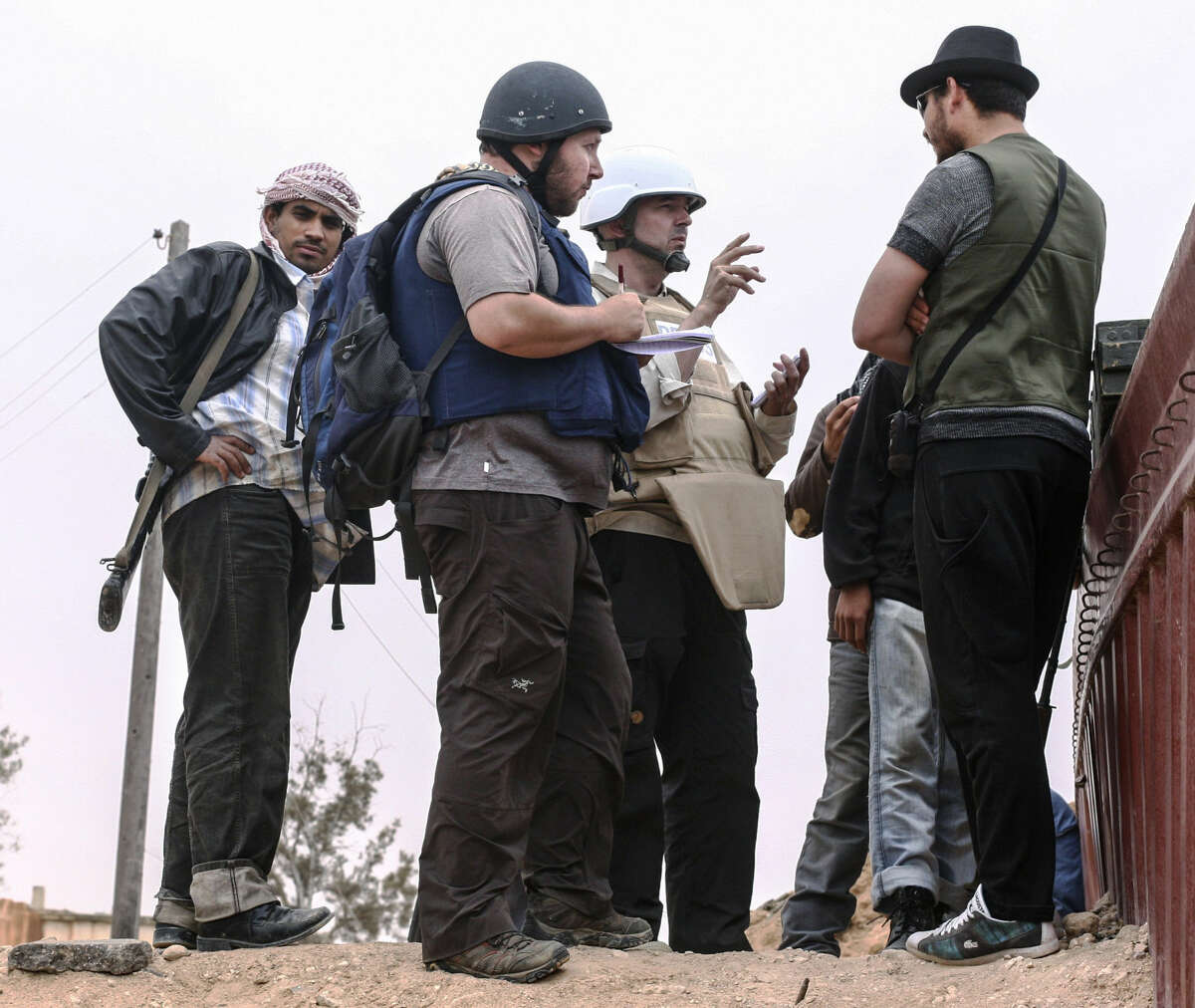 MISRATA, LIBYA - JUNE 02: In this handout image made available by the photographer American journalist Steven Sotloff (Center with black helmet) talks to Libyan rebels on the Al Dafniya front line, 25 km west of Misrata on June 02, 2011 in Misrata, Libya.