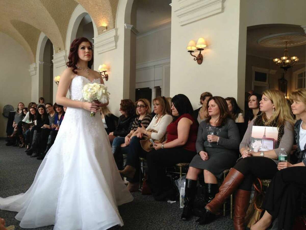 A model walks the catwalk in a dress from Mariella Creations in Rocky Hill for the Wadsworth Mansion’s first-ever bridal fashion show.